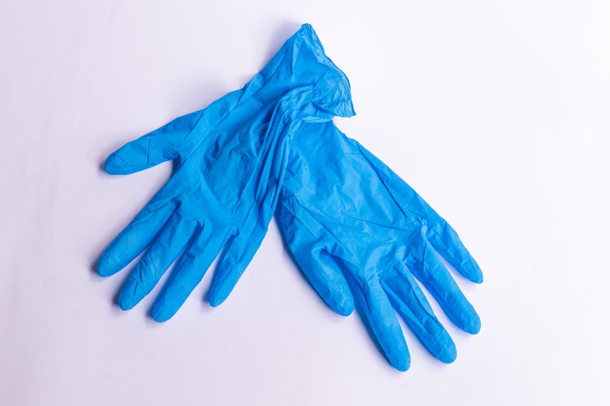 Pair of blue disposable nitrile examination gloves on a clean surface